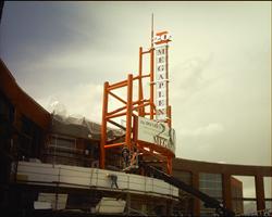 Men work on the front of the theater entrance.  The sign above the entrance is complete. - , Utah